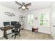 The bedroom has a ceiling fan, neutral paint, and built-in shelving surrounding the desk at 1530 Gristmill Meadows Dr, Westfield, IN 46074