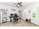 The bedroom has a ceiling fan, neutral paint, and built-in shelving surrounding the desk at 1530 Gristmill Meadows Dr, Westfield, IN 46074