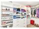 A spacious walk-in closet with white custom shelving and ample storage space for clothes, shoes, and accessories at 1530 Gristmill Meadows Dr, Westfield, IN 46074