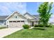 Charming one story home featuring a two-car garage and a cozy front lawn with fresh landscaping at 1530 Gristmill Meadows Dr, Westfield, IN 46074