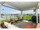 The covered patio area features comfortable seating with a beautiful view of the community pond at 1530 Gristmill Meadows Dr, Westfield, IN 46074