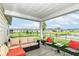 Covered patio with outdoor furniture, offering a relaxing space overlooking the backyard and pond at 1530 Gristmill Meadows Dr, Westfield, IN 46074