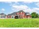 Expansive backyard with lush green grass, playground, and a charming two-story home at 1595 N Blue Rd, Greenfield, IN 46140
