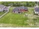 Aerial view of the spacious backyard featuring lush grass, play equipment, and outdoor dining at 1595 N Blue Rd, Greenfield, IN 46140