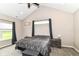Bedroom with vaulted ceiling, fan, and window letting in natural light at 1595 N Blue Rd, Greenfield, IN 46140