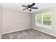 Neutral bedroom featuring a ceiling fan, soft carpet, and a bright window with natural light at 1595 N Blue Rd, Greenfield, IN 46140