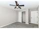 Bedroom with plush carpet, ceiling fan, closet, and white doors at 1595 N Blue Rd, Greenfield, IN 46140