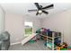 Bedroom with plush carpet, ceiling fan, a window and toys at 1595 N Blue Rd, Greenfield, IN 46140