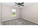 Neutral-toned bedroom featuring a window and plush carpeting at 1595 N Blue Rd, Greenfield, IN 46140