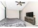 Bedroom with vaulted ceiling, ceiling fan, and dresser with television at 1595 N Blue Rd, Greenfield, IN 46140