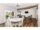 Open floor plan showcasing dining area connecting kitchen to living room with hardwood flooring at 1595 N Blue Rd, Greenfield, IN 46140