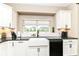 Kitchen sink sits under a window for natural light over modern countertops and backsplash at 1595 N Blue Rd, Greenfield, IN 46140