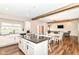 A view of the open-concept kitchen and dining area with hardwood flooring and natural light at 1595 N Blue Rd, Greenfield, IN 46140