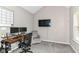 Bright office features grey carpet, a TV, a desk and neutral walls at 1595 N Blue Rd, Greenfield, IN 46140