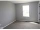 Standard bedroom with neutral carpeting, light gray walls, and a window letting in natural light at 16835 Cheddar Dr, Noblesville, IN 46060