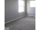 Standard bedroom with neutral carpeting, light gray walls, and a window letting in natural light at 16835 Cheddar Dr, Noblesville, IN 46060