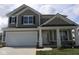 Charming two-story home with a large two-car garage and craftsman-style details at 16835 Cheddar Dr, Noblesville, IN 46060