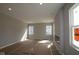 Bright living room featuring a fireplace and large windows at 16835 Cheddar Dr, Noblesville, IN 46060