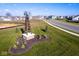 Community landmark with a decorative windmill and landscaping on a verdant lawn at 16835 Cheddar Dr, Noblesville, IN 46060