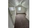 Finished attic with carpet flooring, white walls, storage, and natural light from the window at 1739 Crystal St, Anderson, IN 46012