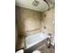 Bathroom with tile flooring, tile walls, white fixtures, and built-in tub bench at 1739 Crystal St, Anderson, IN 46012