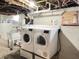 Laundry area with a modern washer and dryer set and a utility sink at 1739 Crystal St, Anderson, IN 46012