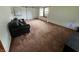 Spacious living room with sliding barn door and a cozy black sofa at 1739 Crystal St, Anderson, IN 46012