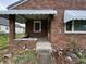 Charming front porch with brick surround and stairs leading up to front door at 1739 Crystal St, Anderson, IN 46012