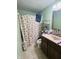 Well-maintained bathroom featuring a vanity, seashell shower curtain, and toilet at 1809 N Harding St, Indianapolis, IN 46202