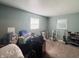 Empty bedroom with carpeted floors and two windows allowing natural light to enter the room at 1809 N Harding St, Indianapolis, IN 46202