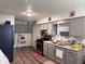 Functional kitchen with gray cabinets, updated appliances, and wood-look flooring at 1809 N Harding St, Indianapolis, IN 46202