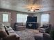 Comfortable living room with a large TV, plush seating, and plenty of natural light at 1809 N Harding St, Indianapolis, IN 46202