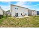 A backyard with a patio set, grill, and partial fence at 1893 Glenmoor Ct, Columbus, IN 47201