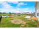 Spacious backyard with patio, play set, pond view, and black fencing at 1893 Glenmoor Ct, Columbus, IN 47201