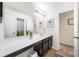 Bright bathroom with a long vanity, modern lighting, and a large mirror above the countertop at 1893 Glenmoor Ct, Columbus, IN 47201