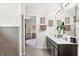 Stylish bathroom with a double vanity, modern lighting, decorative accents, and an adjoining room at 1893 Glenmoor Ct, Columbus, IN 47201