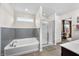 Modern bathroom featuring a soaking tub, glass-enclosed shower, and neutral color palette at 1893 Glenmoor Ct, Columbus, IN 47201