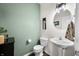 Charming half bath with pedestal sink, modern lighting, and stylish decor at 1893 Glenmoor Ct, Columbus, IN 47201