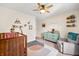 Stylishly decorated Bedroom with wood crib, a pastel dresser, glider and playful wall décor at 1893 Glenmoor Ct, Columbus, IN 47201