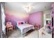 Charming bedroom with a colorful mountain mural, soft carpet and bright, natural light at 1893 Glenmoor Ct, Columbus, IN 47201