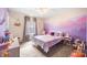 Charming bedroom with a colorful mountain mural, soft carpet and bright, natural light at 1893 Glenmoor Ct, Columbus, IN 47201