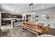 Open-concept breakfast nook boasts a modern light fixture, hardwood floors, and seamlessly flows into the kitchen at 1893 Glenmoor Ct, Columbus, IN 47201