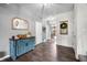 Bright entryway showcasing a decorative cabinet, wood floors, and welcoming decor at 1893 Glenmoor Ct, Columbus, IN 47201