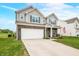 Charming two-story home with a manicured lawn, attached two-car garage, and inviting front porch at 1893 Glenmoor Ct, Columbus, IN 47201