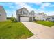 Well-maintained home with a lush green lawn, attached two-car garage, neutral siding, and inviting curb appeal at 1893 Glenmoor Ct, Columbus, IN 47201