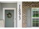 Close up view of the Front door and the address numbers of the property at 1893 Glenmoor Ct, Columbus, IN 47201