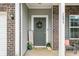 Inviting front porch with a welcoming wreath, seating, and charming decor at 1893 Glenmoor Ct, Columbus, IN 47201