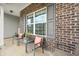 Inviting front porch with brick accents, seating and decor at 1893 Glenmoor Ct, Columbus, IN 47201