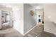 Hallway with neutral walls, gray accent wall, carpet, and doors leading to various rooms at 1893 Glenmoor Ct, Columbus, IN 47201