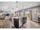 Open kitchen with an island, stainless steel appliances, granite countertops, and views into the breakfast nook and Gathering room at 1893 Glenmoor Ct, Columbus, IN 47201